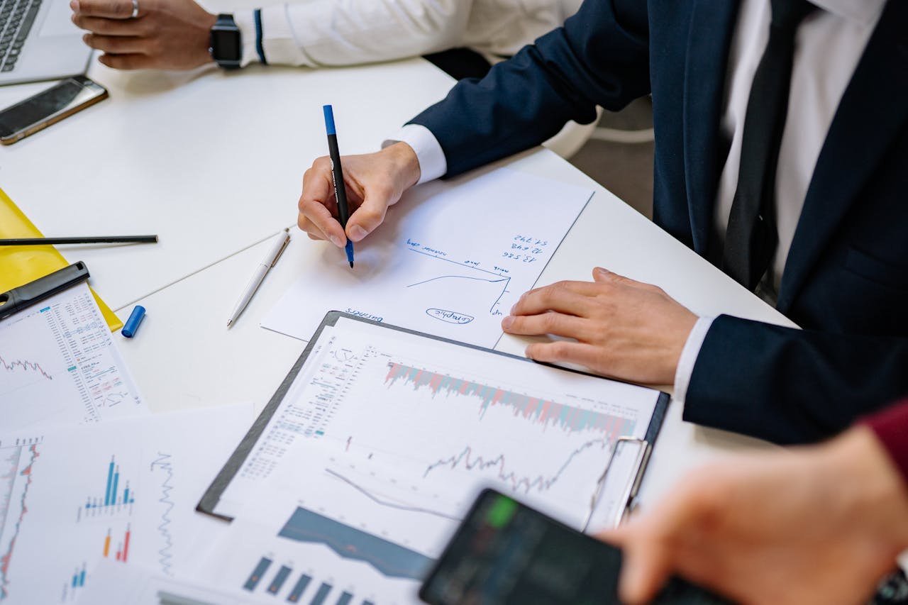 about-01 Professionals analyzing financial charts in a corporate setting.